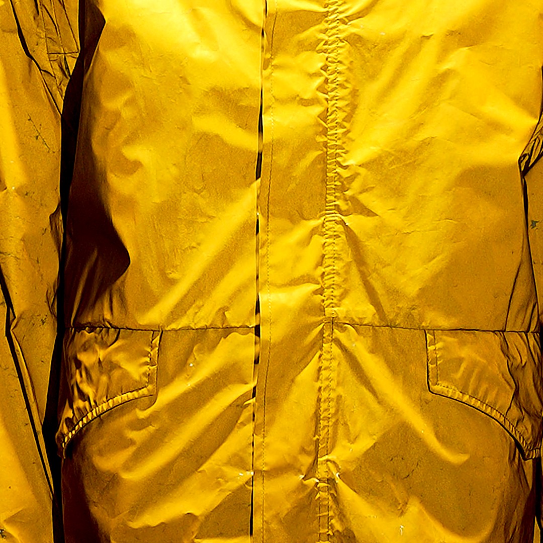 Glossy coated surface and seam of a Stone Island reflective jacket